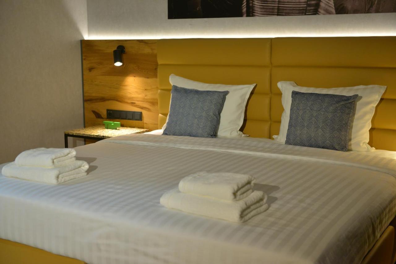 Mk Hotel Tirana Rinas Kültér fotó A bed with a headboard
